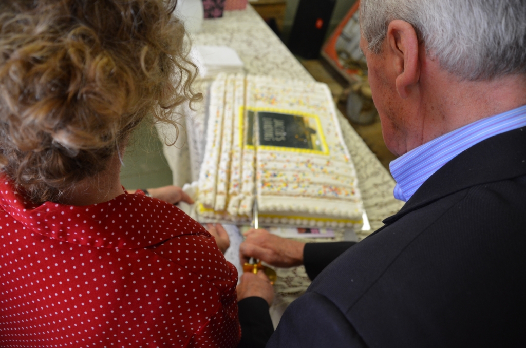 Author Daphne Greer and her father cut the "Jacob's Landing" cake (with a sword!) at the book launch in Newport Landing, NS, on Saturday, May 30. Photo courtesy of Nimbus Publishing.