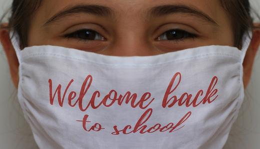 Photo Of girl wearing mask that says "welcome back to school"